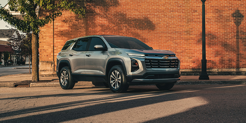 Chevrolet Equinox parked in front of a brick building, showcasing its modern design and urban setting.