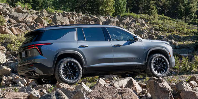 A Chevrolet Traverse, a rugged SUV, showcasing its bold design and off-road capabilities in a natural setting.